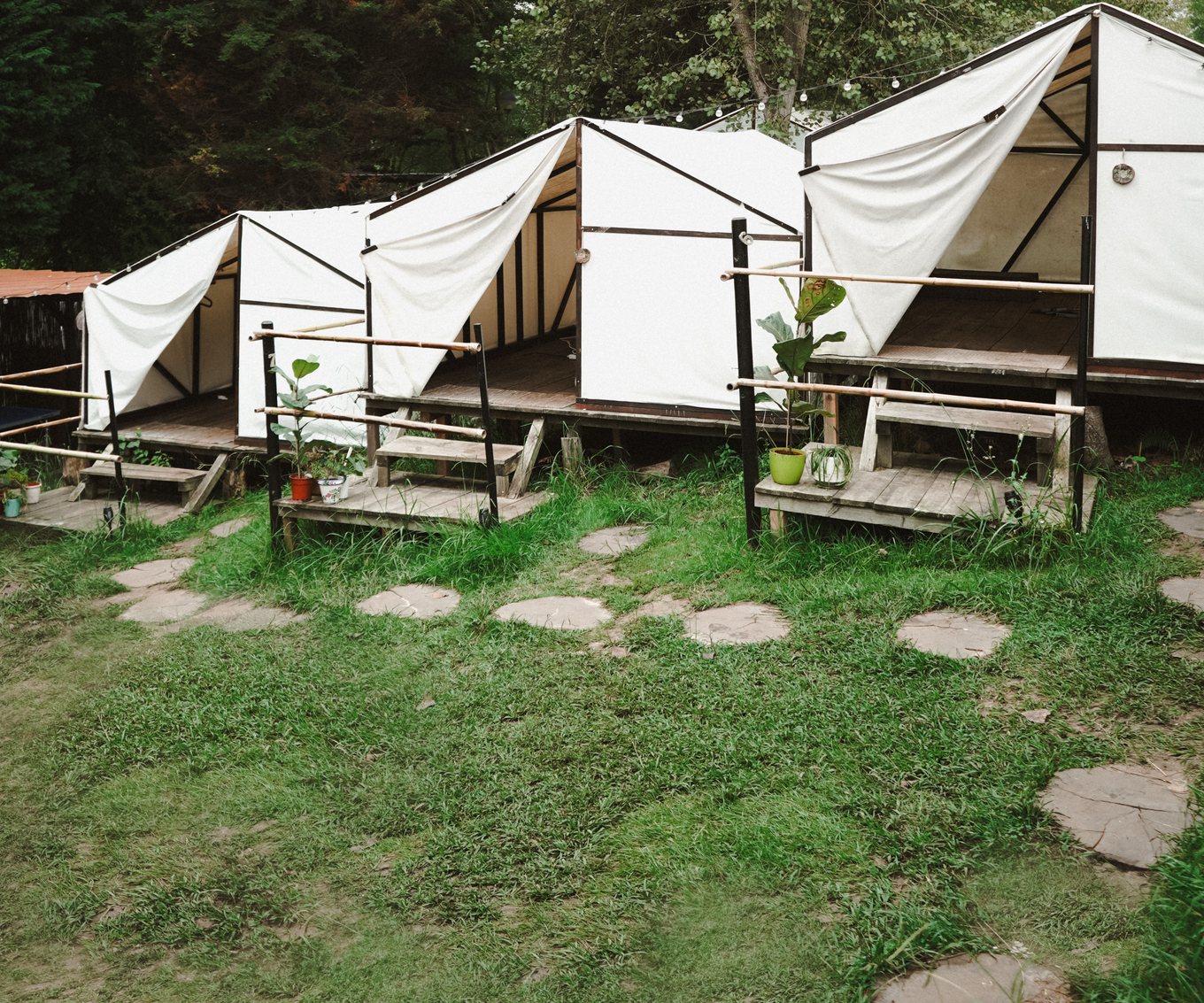 the glamping tents at amigos spain, in a row along a stone path